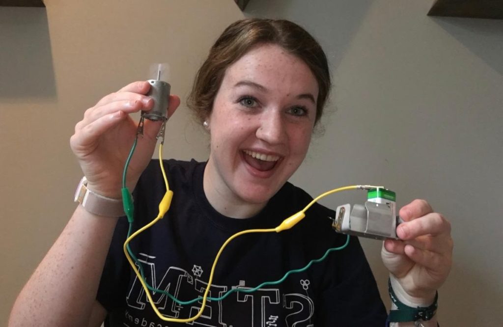 Female student holding a homemade wiring harness
