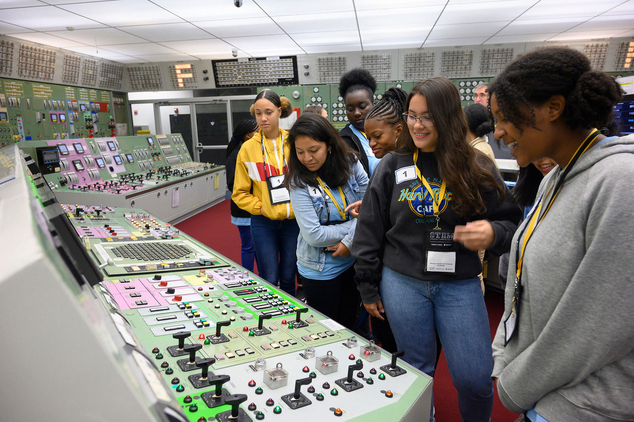 Female students at a power station control board