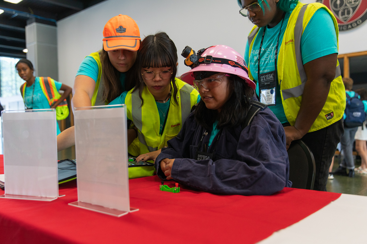 Girls reading a sign on a table